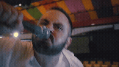 Man Singing Into Microphone Saying Pack Your GIF