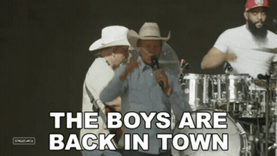 Man Singing Into Microphone The Boys Are Back In Town GIF
