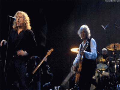 Man Singing Into Microphone While Man Plays Guitar GIF