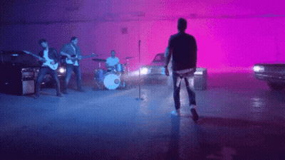Man Singing Into Microphone With Band GIF