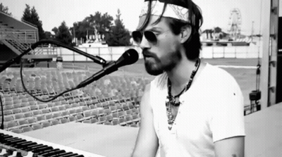 Man Singing Into Microphone With Bandana GIF