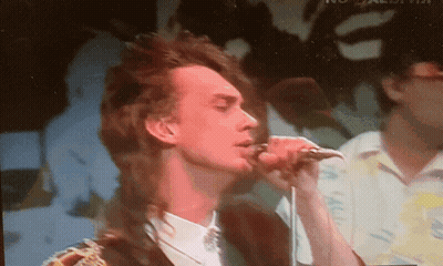 Man Singing Into Microphone With Bird Shadow GIF