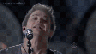 Man Singing Into Microphone With CBS Logo GIF