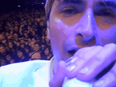 Man Singing Into Microphone With Crowd GIF