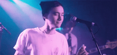 Man Singing Into Microphone With Guitar GIF