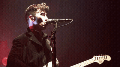 Man Singing Into Microphone With Guitar GIF