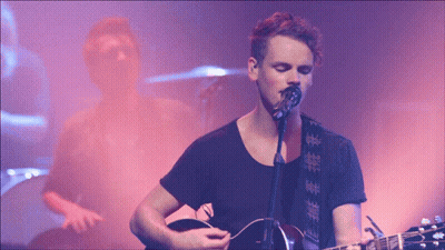 Man Singing Into Microphone With Guitar GIF