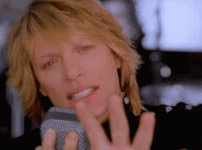 Man Singing Into Microphone With Hand Outstretched GIF