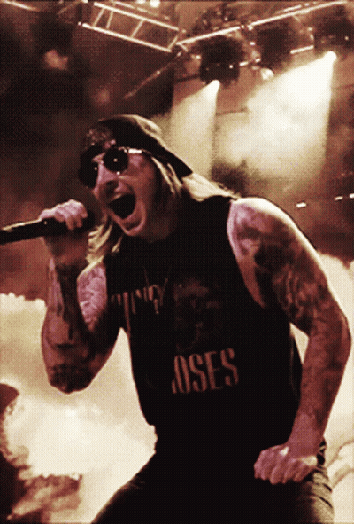 Man Singing Into Microphone With Roses Shirt GIF