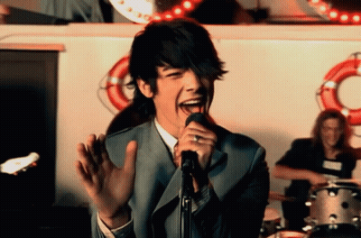 Man Singing Into Microphone With Tongue Out