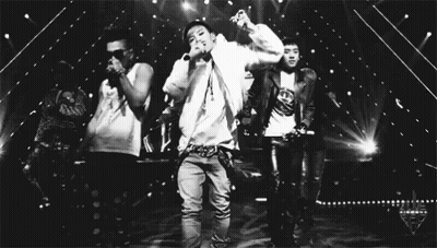 Man Singing Into Microphone With Two Men Dancing Behind GIF