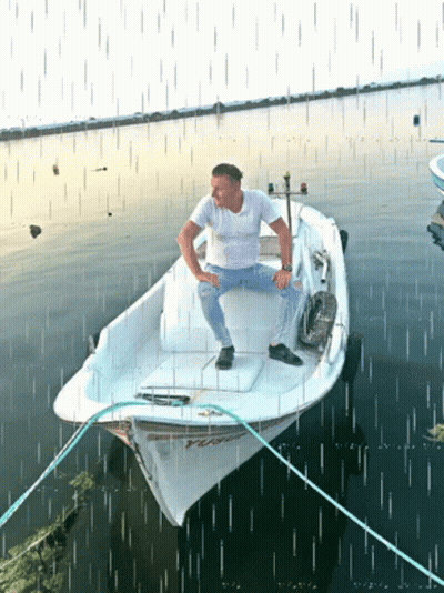 Man Sits On Boat Saying TC GIF