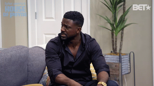 Man Sits On Couch With BET Logo GIF