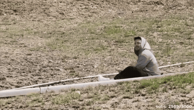 Man Sits On White Object With Number 3000 GIF