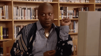 Man Sitting At Computer In Library GIF