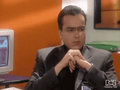 Man Sitting At Computer With Nuestra Tele Shirt GIF