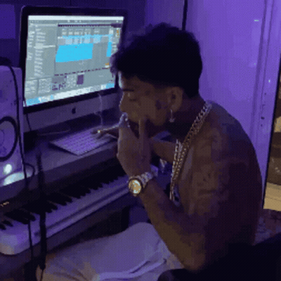 Man Sitting At Computer With Purple Background GIF