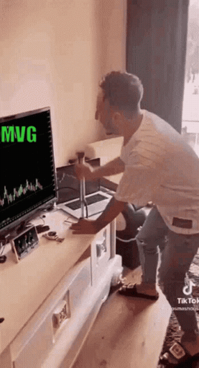 Man Sitting At Desk In Front Of Computer GIF