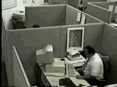 Man Sitting At Desk In Office Cubicle With Computer GIF
