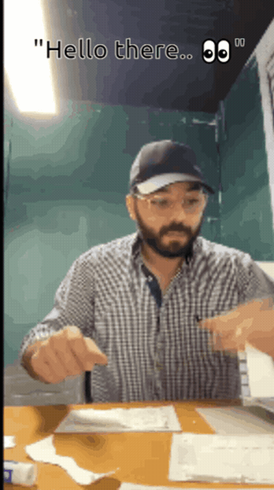 Man Sitting At Desk Saying Hello There GIF