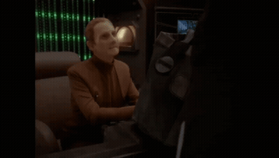 Man Sitting At Desk Saying Ohh Let Me See GIF