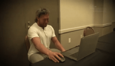 Man Sitting At Desk Using Laptop GIF