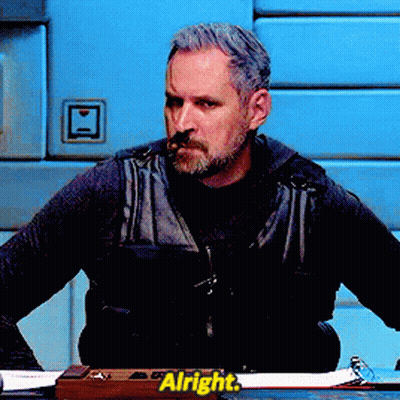 Man Sitting At Desk With Alright Sign GIF
