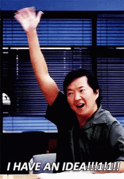 Man Sitting At Desk With Arm In Air GIF