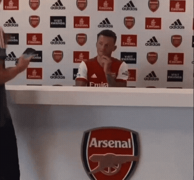 Man Sitting At Desk With Arsenal Logo GIF