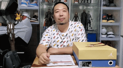 Man Sitting At Desk With Box Of Air Jordans GIF