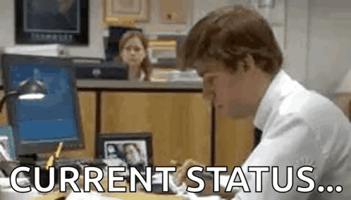 Man Sitting at Desk with Current Status