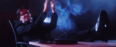Man Sitting At Desk With Feet And Hands Up GIF