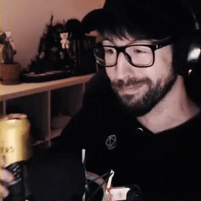 Man Sitting At Desk With Glasses And Headphones GIF