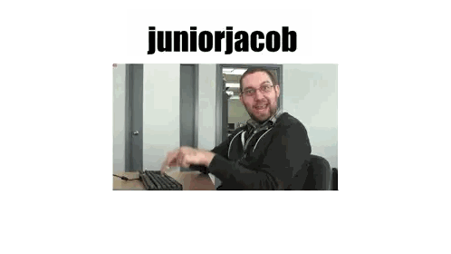 Man Sitting At Desk With Juniorjacob Name Sticker