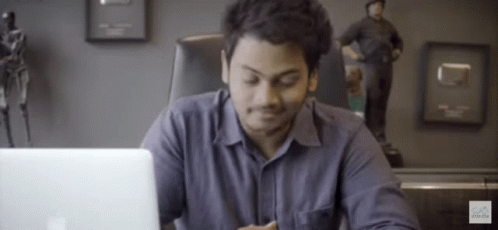 Man Sitting At Desk With Laptop GIF