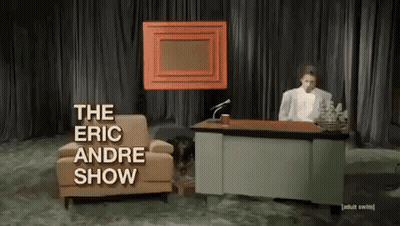 Man Sitting At Desk With The Eric Andre Show GIF