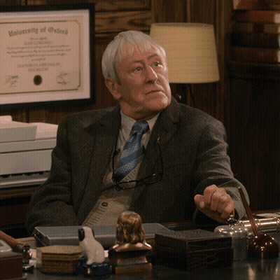 Man Sitting At Desk With University Of Oxford Diploma GIF