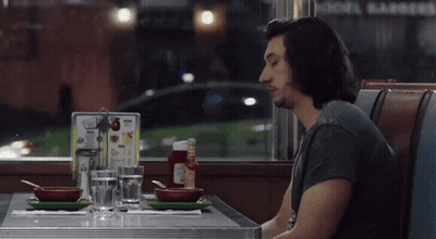 Man Sitting At Diner Table Saying Good Slop GIF