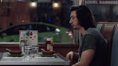 Man Sitting At Diner Table With Menu GIF