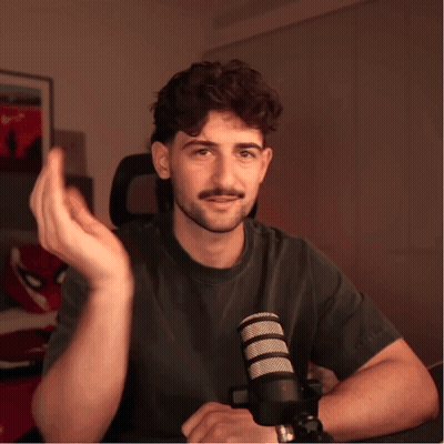 Man Sitting At Microphone Hand Outstretched GIF