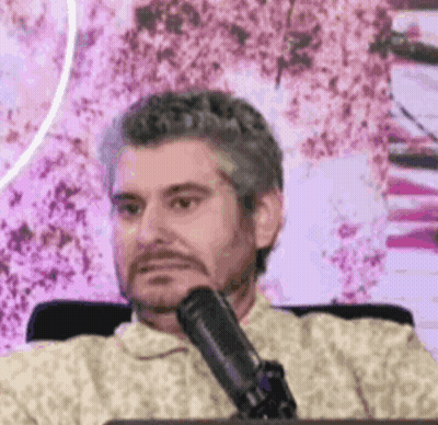 Man Sitting At Microphone Making Funny Face GIF