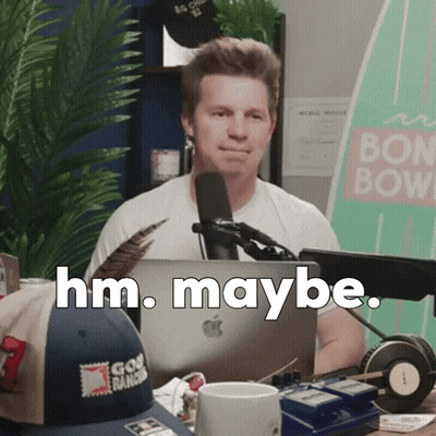 Man Sitting at Microphone Saying Hm Maybe