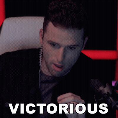 Man Sitting At Microphone Victorious GIF