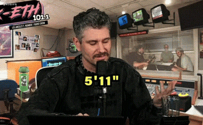 Man Sitting At Microphone With Eth 101.1 Sign GIF