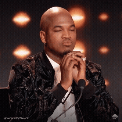 Man Sitting At Microphone With Eyes Closed Praying GIF