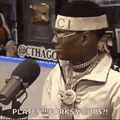 Man Sitting At Microphone With Gucci Headband GIF