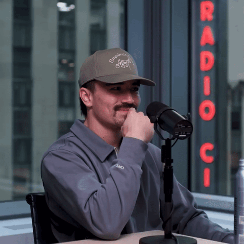 Man Sitting At Microphone With Radio C Sign GIF