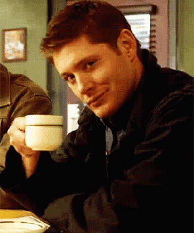 Man Sitting At Table Drinking Coffee GIF