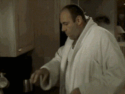 Man Sitting At Table Drinking From Cup GIF