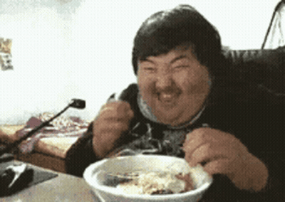 Man Sitting At Table Eating Bowl Of Food GIF